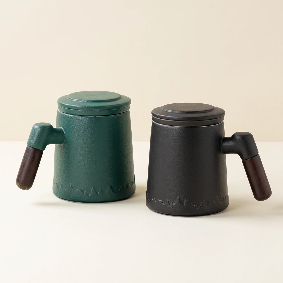 Everest ceramic tea infuser mugs in Noir Black and Forest Green, side by side