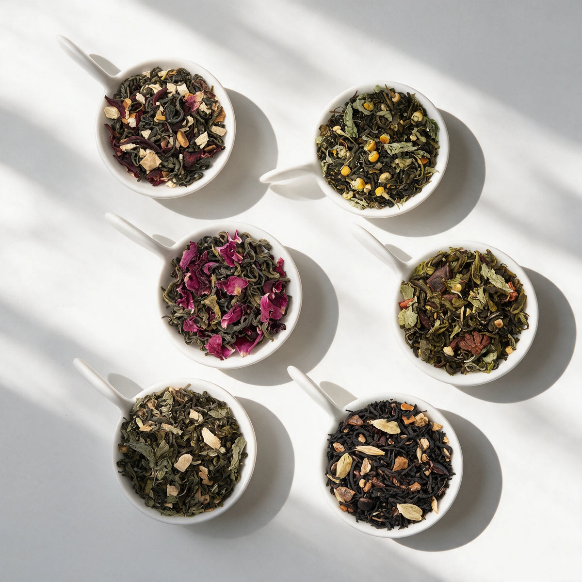 The six loose teas in the Floral & Fruit Tea Sampler Pack, in white bowls