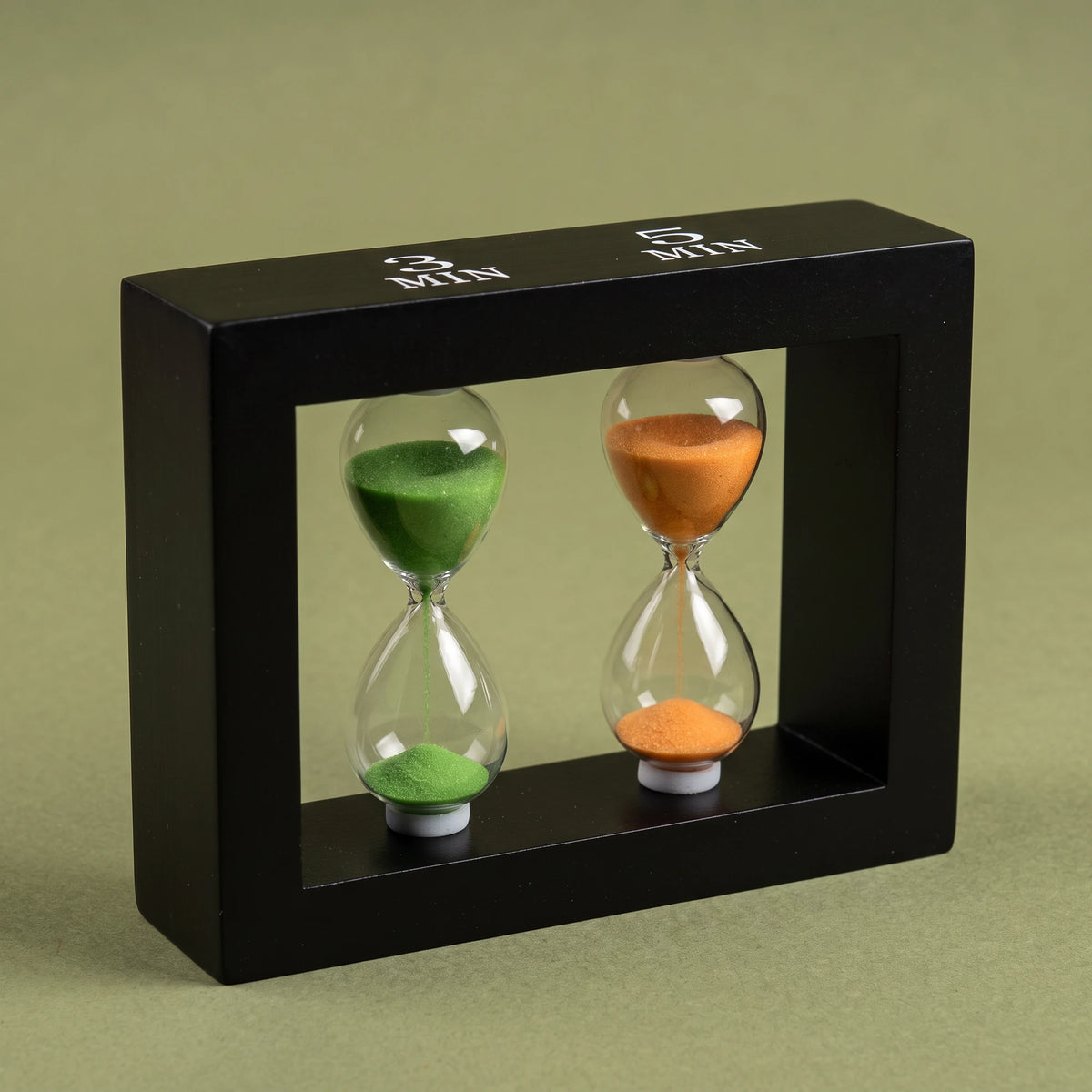 Close-up of the green and orange sand in the Happy Hour tea timer