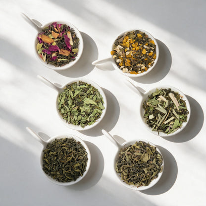 The six loose teas in the Herbal Tea Sampler Pack, in white bowls