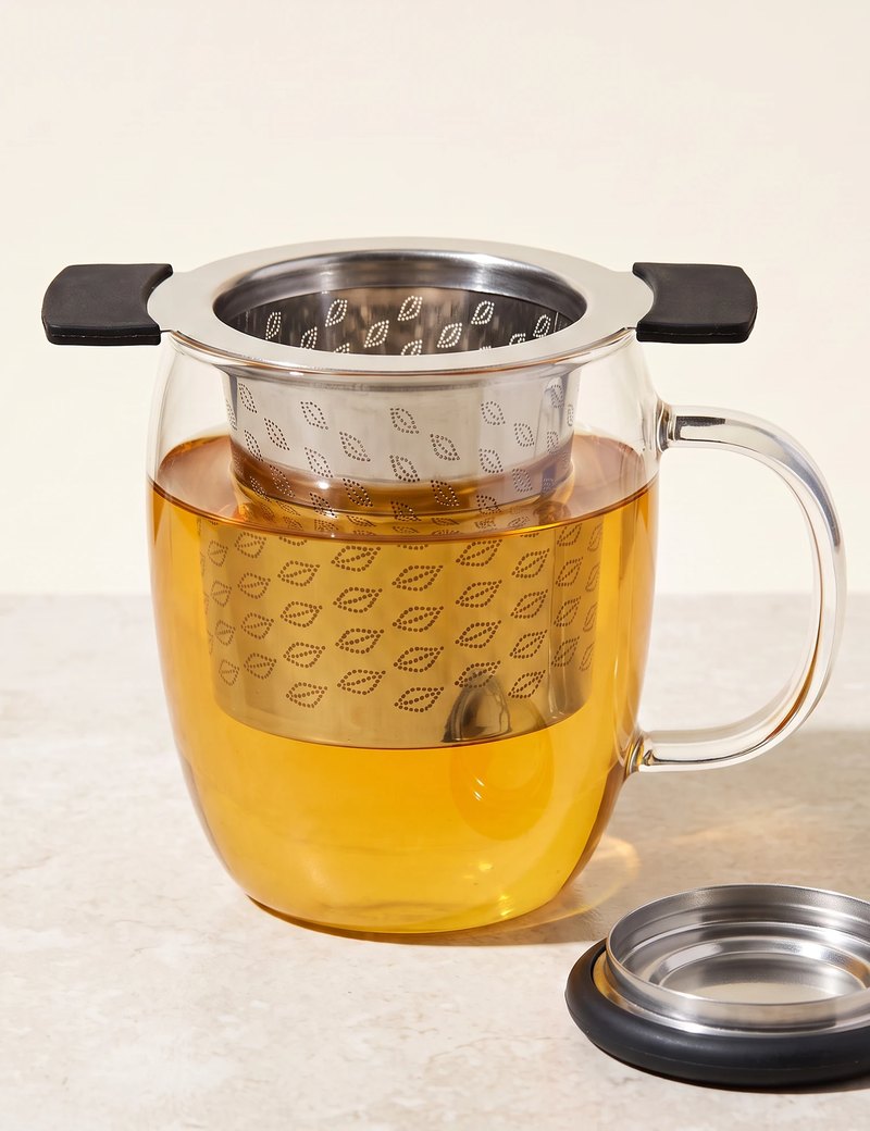 Perfect tea infuser resting in a glass mug of tea