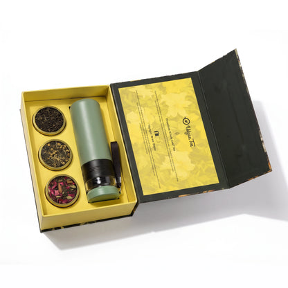 Manthan gift box open, with a green tea brewing bottle and three tins of tea