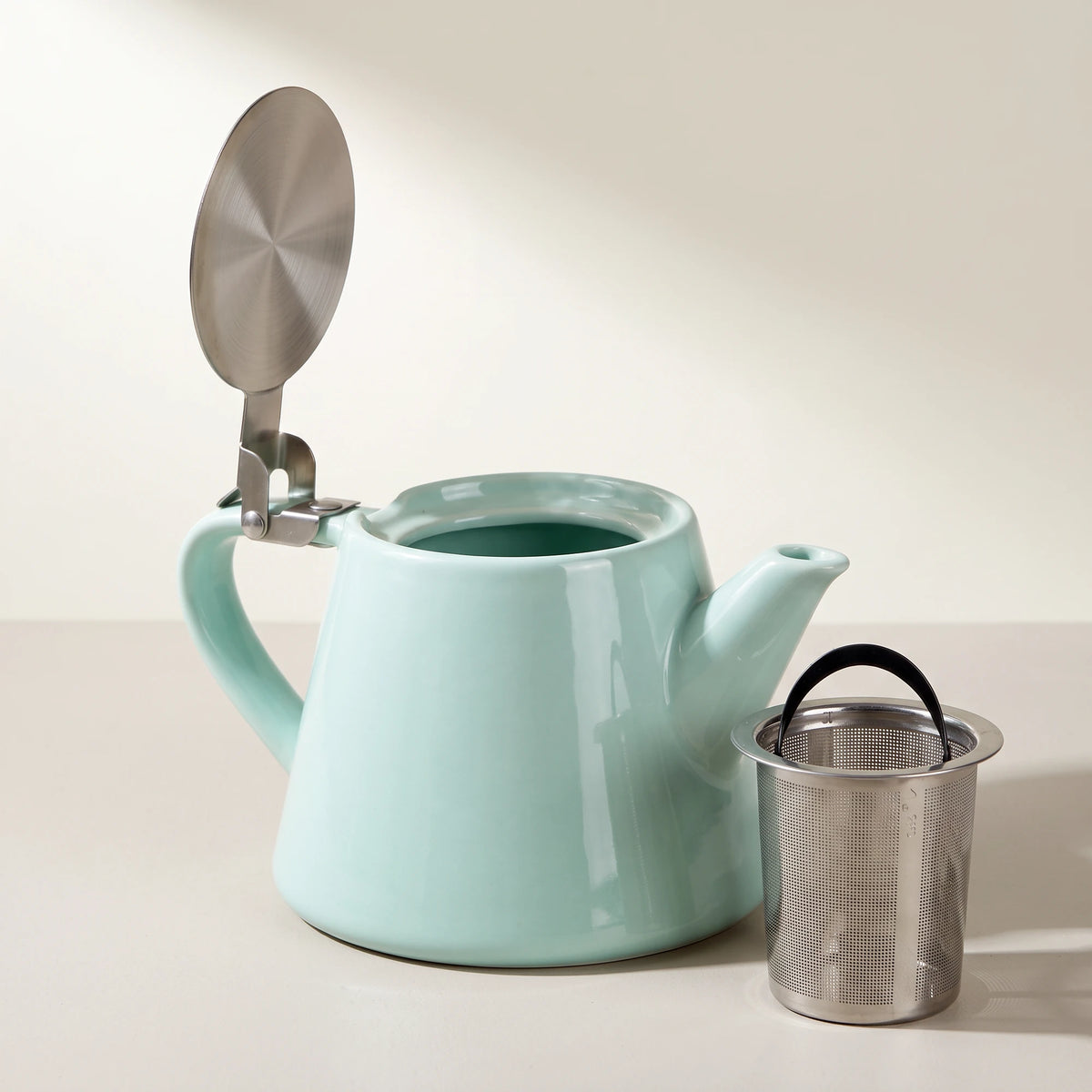 Muse ceramic teapot with infuser, Aqua Blue, lid open, infuser beside the teapot