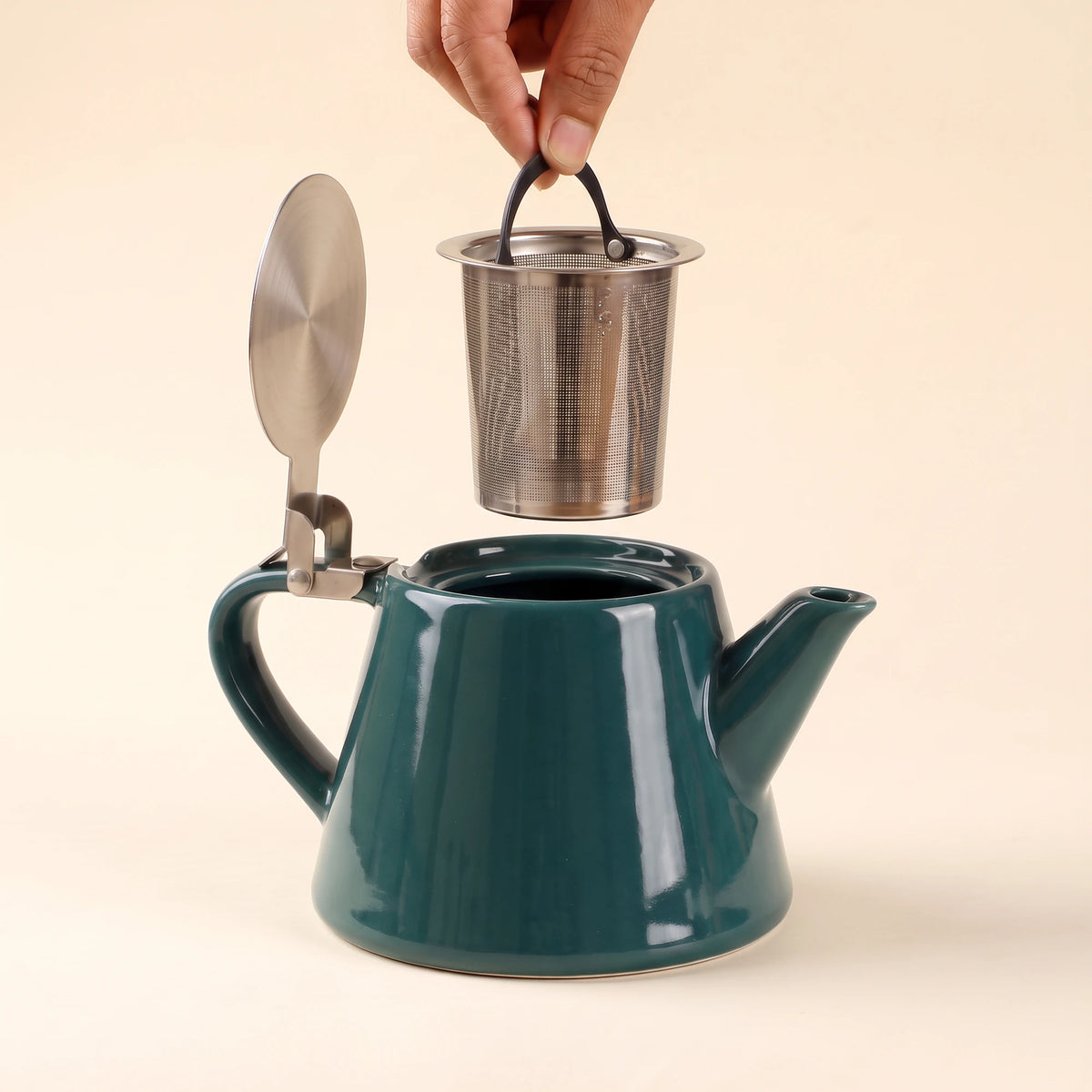 Muse ceramic teapot with infuser, Jade Green, infuser being lifted out of the teapot
