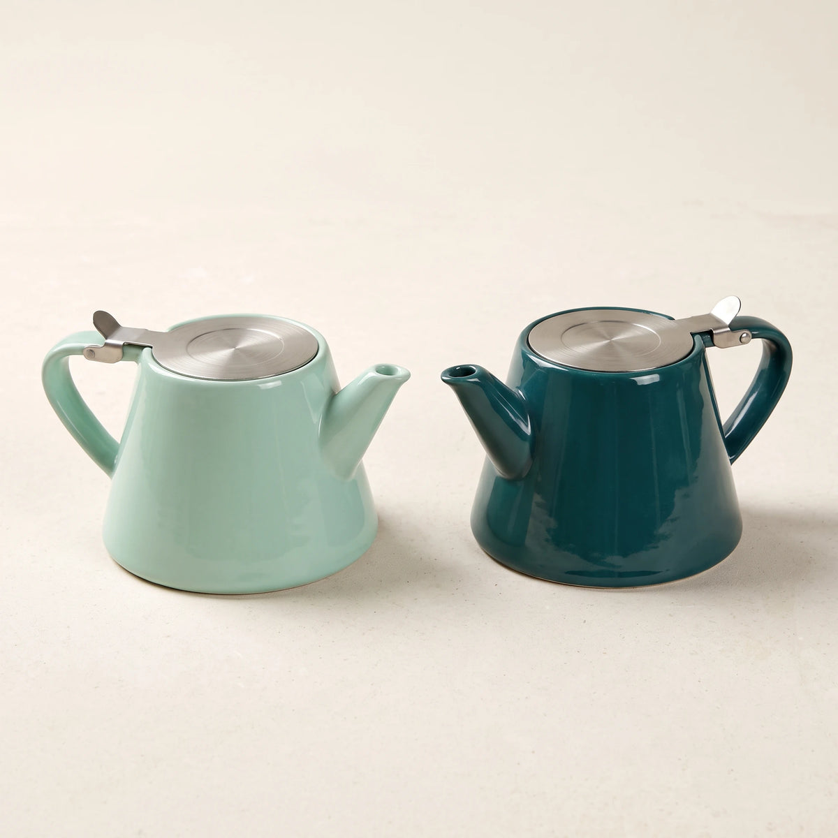 Muse ceramic teapots in Jade Green and Aqua Blue, side by side