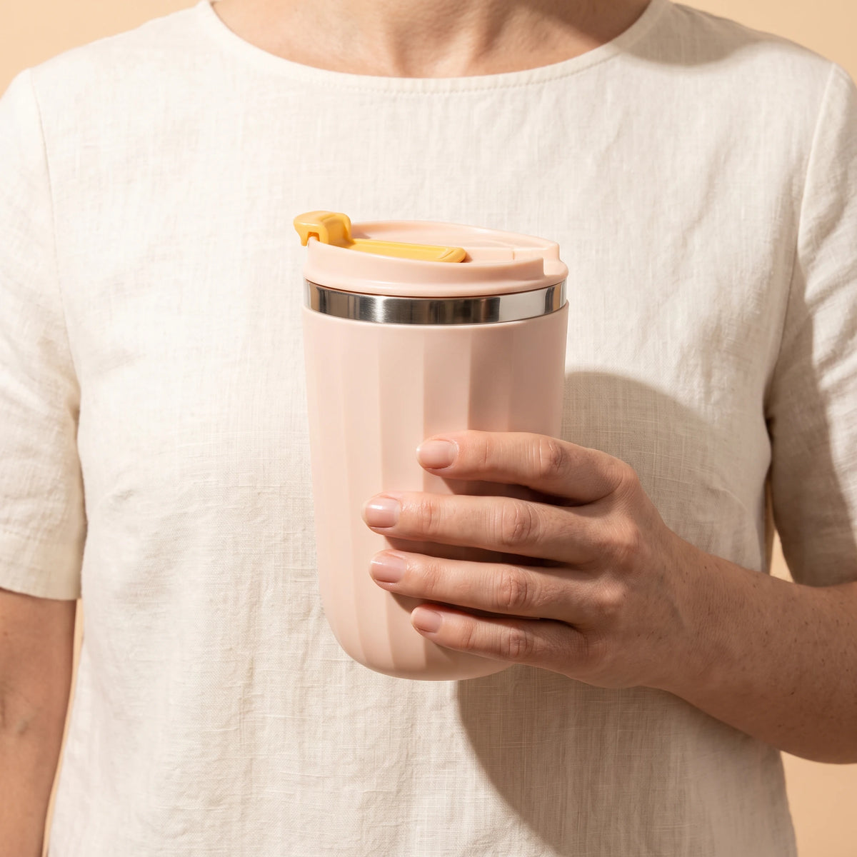 Opal travel tumbler, Blush Pink, held in hand
