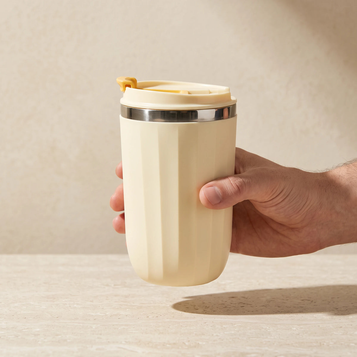 Opal travel tumbler, Honey Yellow, held in hand