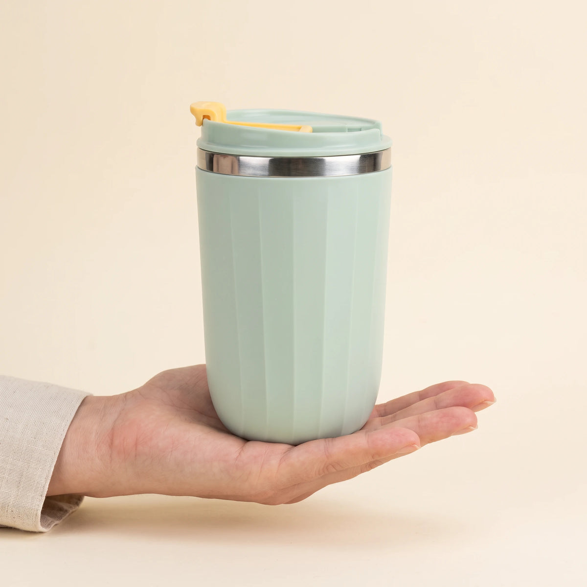 Opal travel tumbler, Sage Green, held in hand
