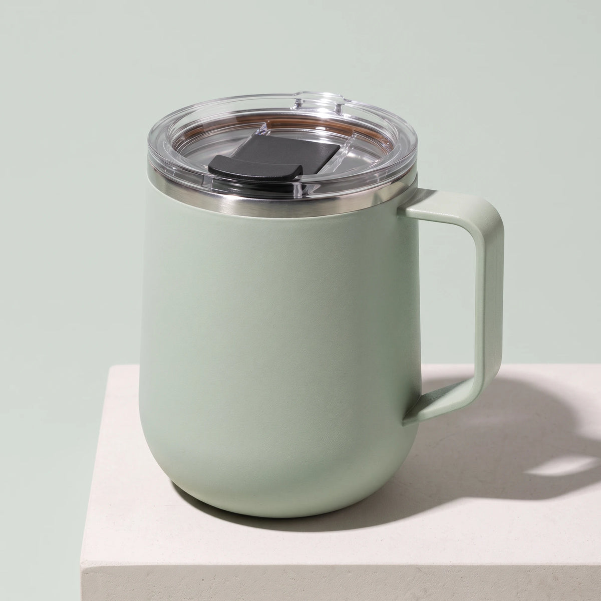 Pulse travel mug, Mint Green, on a stone tile