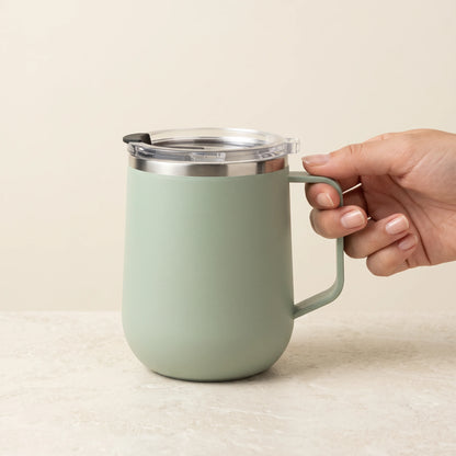 Pulse travel mug, Mint Green, held by the handle