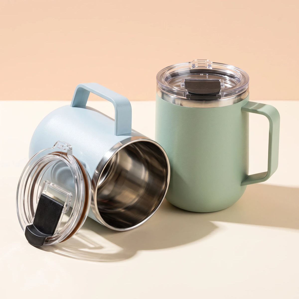 Pulse travel mugs in Frost Blue and Mint Green, side by side