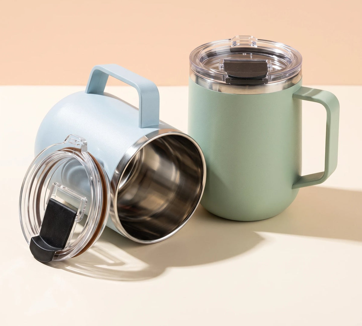 Pulse travel mugs in Frost Blue and Mint Green, side by side
