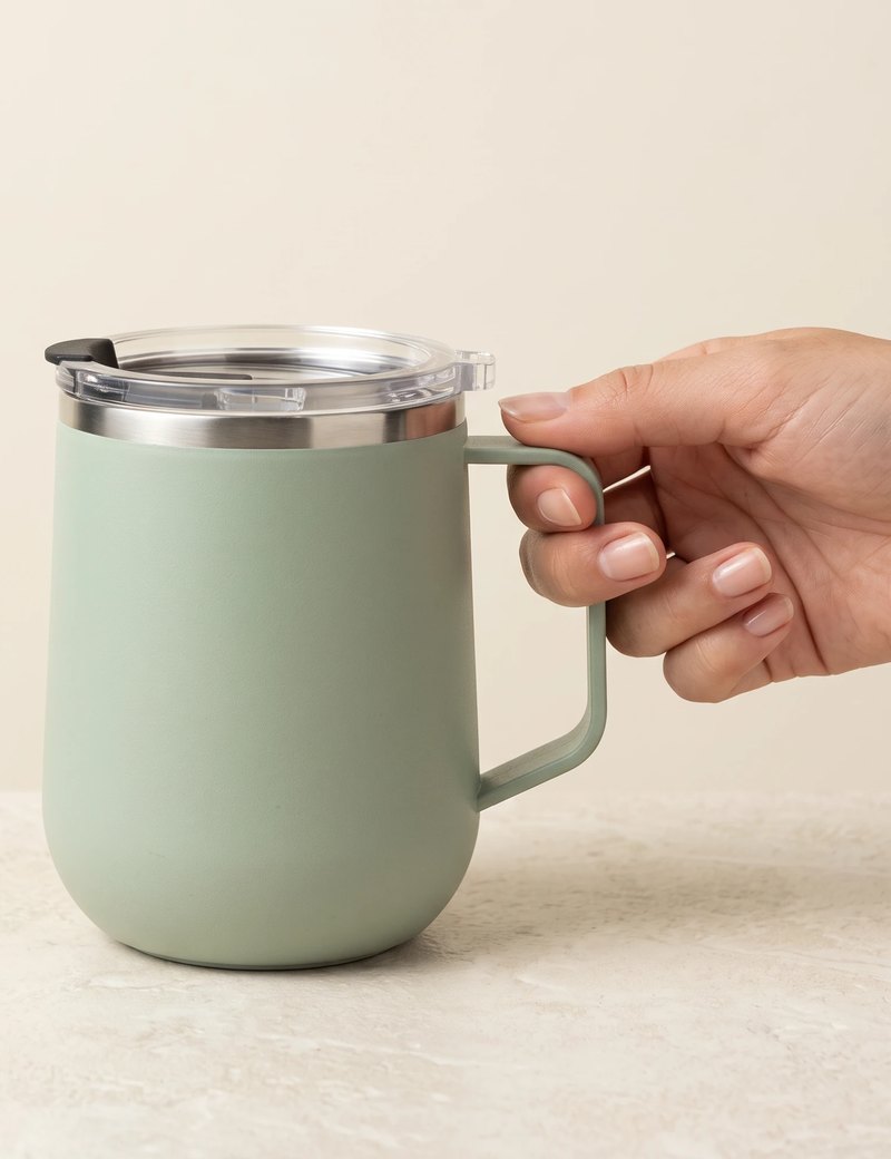 Pulse travel mug, Mint Green, held by the handle