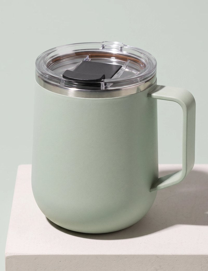 Pulse travel mug, Mint Green, on a stone tile